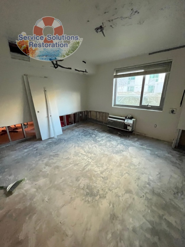 Image of a room being repaired for water damage in san diego, with the flooring removed